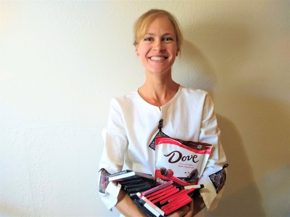 Dr. Jennifer Schmidt holding her pre-Covid chocolate stash, which is now gone!