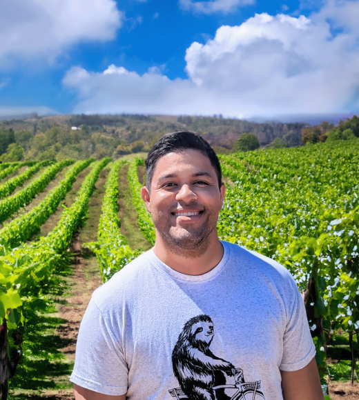 Jadran standing with a vineyard in the background.